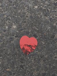 High angle view of heart shape on wet rock