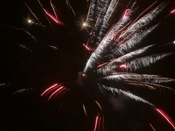 Low angle view of firework display at night