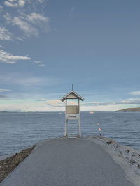 Lifeguard hut on beach against sky