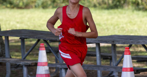 Low section of woman exercising on field