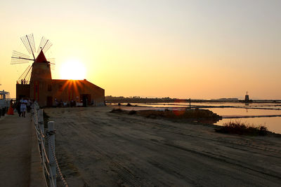 Scenic view of beach against clear sky during sunset