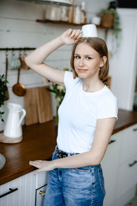 Portrait of young woman standing in bathroom