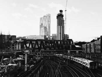 High angle view of railway tracks in city against sky