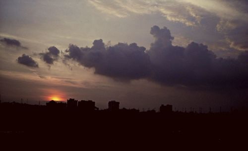 Silhouette of cityscape at sunset