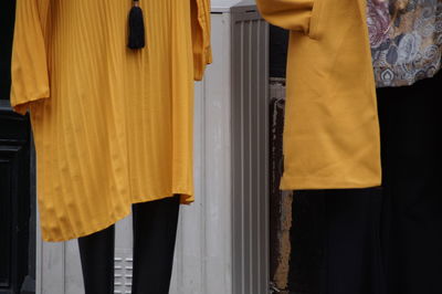 Midsection of man standing on yellow fabric