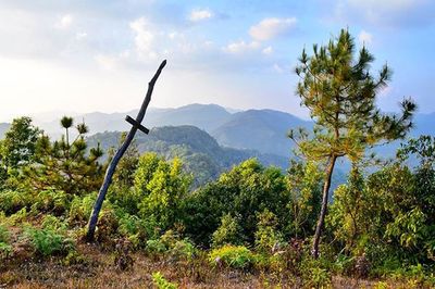 Scenic view of mountains against cloudy sky