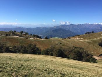 Scenic view of mountain range against blue sky