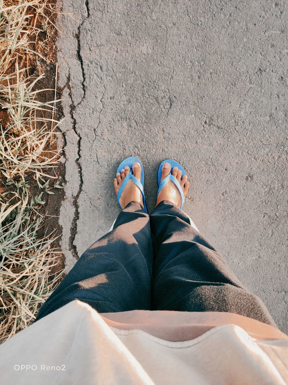 LOW SECTION OF MAN WEARING SHOES STANDING OUTDOORS