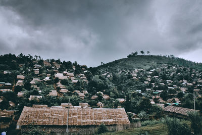 Buildings in city against cloudy sky