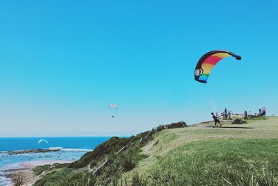 View of parachuting against calm sea