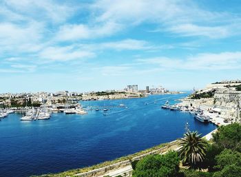 View of harbor against cloudy sky