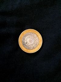 Close-up of coins on black background