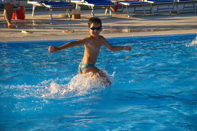 Full length of shirtless boy in swimming pool