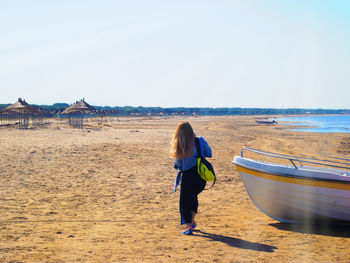 Rear view of man walking on beach