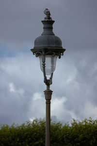 Low angle view of street light against cloudy sky