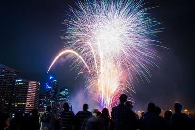 Low angle view of firework display at night