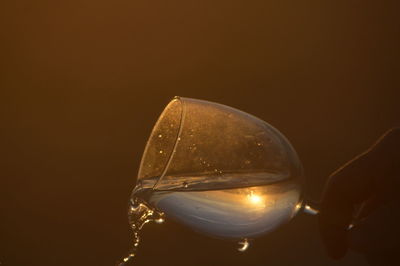 Close-up of hand spilling wine