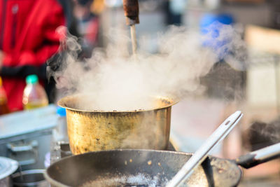 Close-up of steam emitting from food cooking on stove