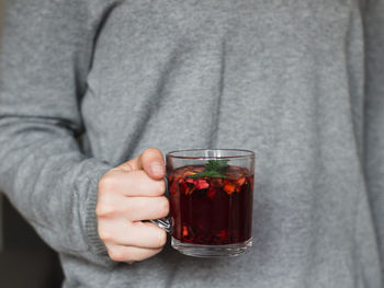 Midsection of woman holding herbal tea