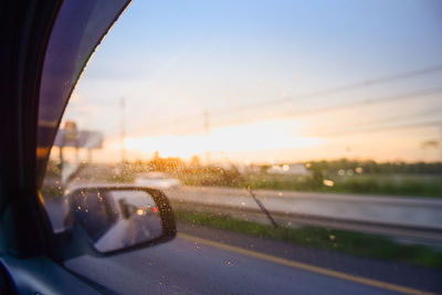 Car on road seen through window