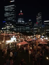 People on illuminated city at night