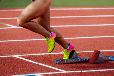 Low section of woman exercising on playing field