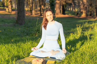 Woman sitting on field