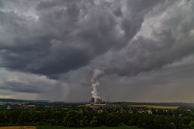 Coal burning power plant against cloudy sky