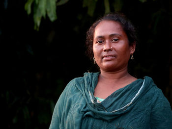 Portrait of young woman standing outdoors