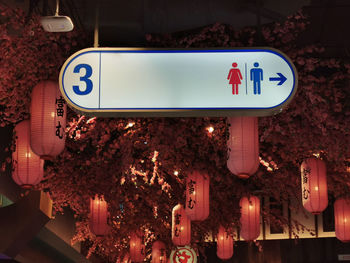 Low angle view of road sign at night