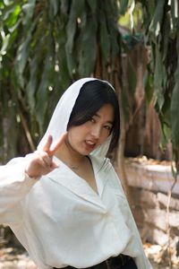 Portrait of young woman standing outdoors