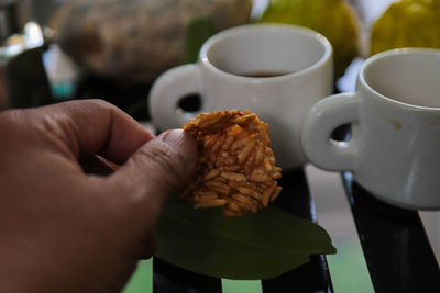 Close-up of hand holding thai snack,khao tang