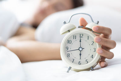 Midsection of woman lying down on bed