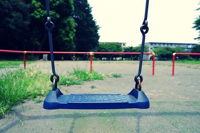 Close-up of empty swing in park