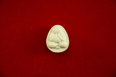 Directly above shot of drink against red background