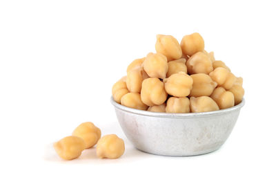 Close-up of eggs in bowl against white background