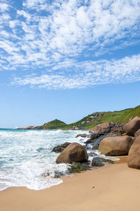 Rocks on beach against sky