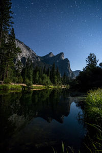 Scenic view of lake against sky at night