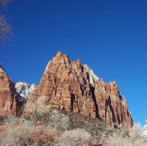 Low angle view of rocks against blue sky