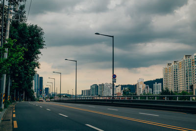 City street and buildings against sky