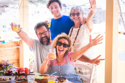 Portrait of happy friends enjoying at table