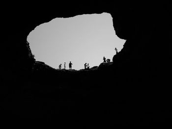 Low angle view of silhouette people against clear sky