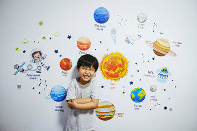 Digital composite image of smiling boy against wall
