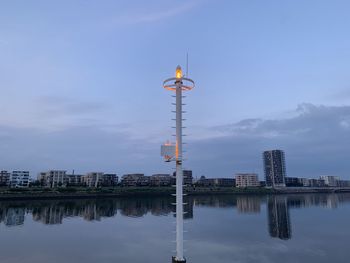 Reflection of buildings in lake against sky