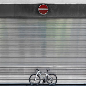 Bicycle parked against wall