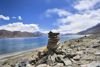 Stack of rocks on beach against sky