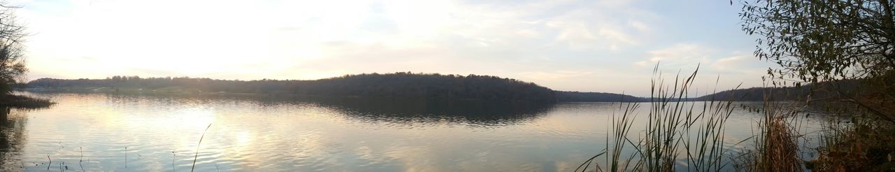 Scenic view of lake against sky at sunset