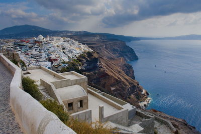 High angle view of townscape by sea against sky