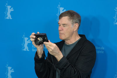 Man standing against blue background