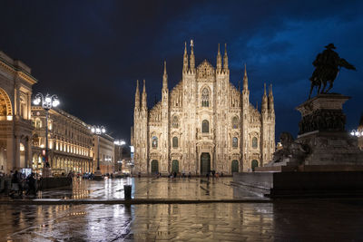 Illuminated buildings against sky at night